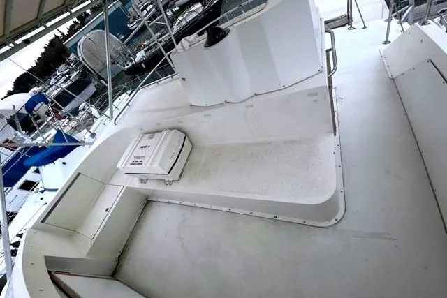 Slide: The Image of Deck of a 1984 Bertram 54 Convertible boat in harbor. - 35