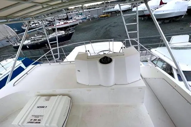 Slide: The Image of 1984 Bertram 54 Convertible yacht in harbor, upper helm station. - 36