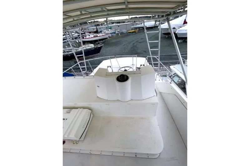 Slide: The Image of 1984 Bertram 54 Convertible Yacht in harbor. - 37