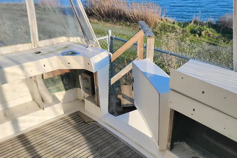 Slide: The Image of 1984 Bertram 54 Convertible boat deck with ocean view and wooden railing. - 4