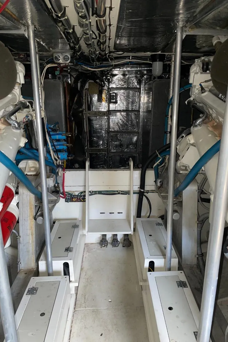 Slide: The Image of Engine room of 1984 Bertram 54 Convertible, showcasing machinery and wiring. - 46