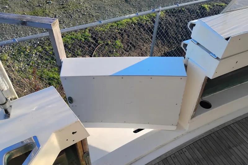 Slide: The Image of 1984 Bertram 54 Convertible boat deck with storage compartments and railing. - 5