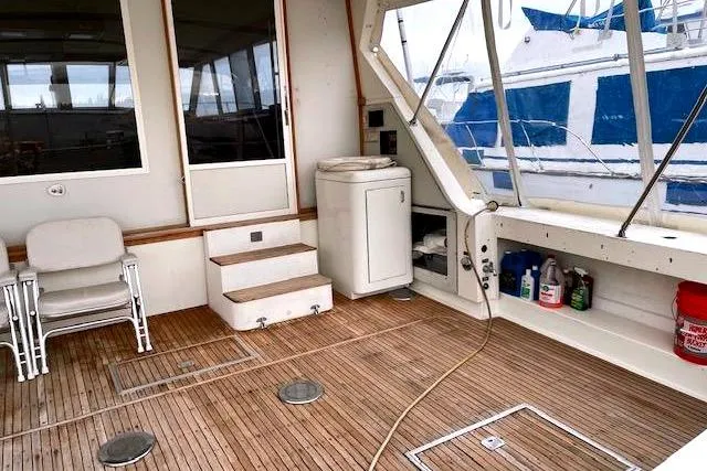 Slide: The Image of Interior of a 1984 Bertram 54 Convertible yacht with wooden flooring. - 6