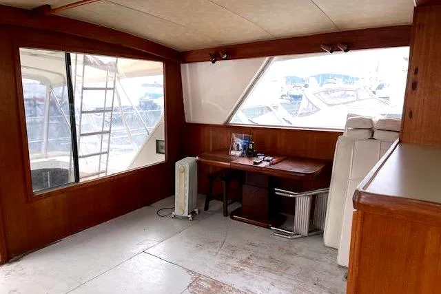 Slide: The Image of Interior of a 1984 Bertram 54 Convertible yacht with desk. - 9