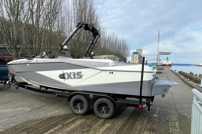 Slide: The Image of 2024 Axis T220 boat on trailer by waterfront, ready for launch. - 22
