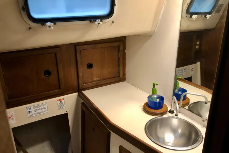 Slide: The Image of 1972 C&C 35 MKI yacht bathroom with sink, mirror, and wooden cabinets. - 12
