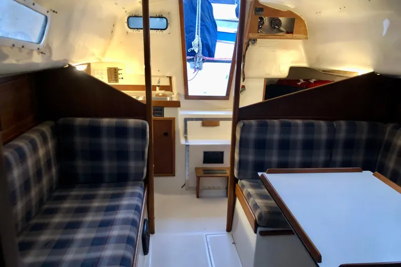 Slide: The Image of 1972 C&C 35 MKI sailboat interior with plaid seating and wooden accents. - 13
