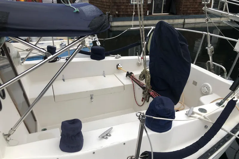 Slide: The Image of 1972 C&C 35 MKI sailboat cockpit with covered equipment and ropes. - 3