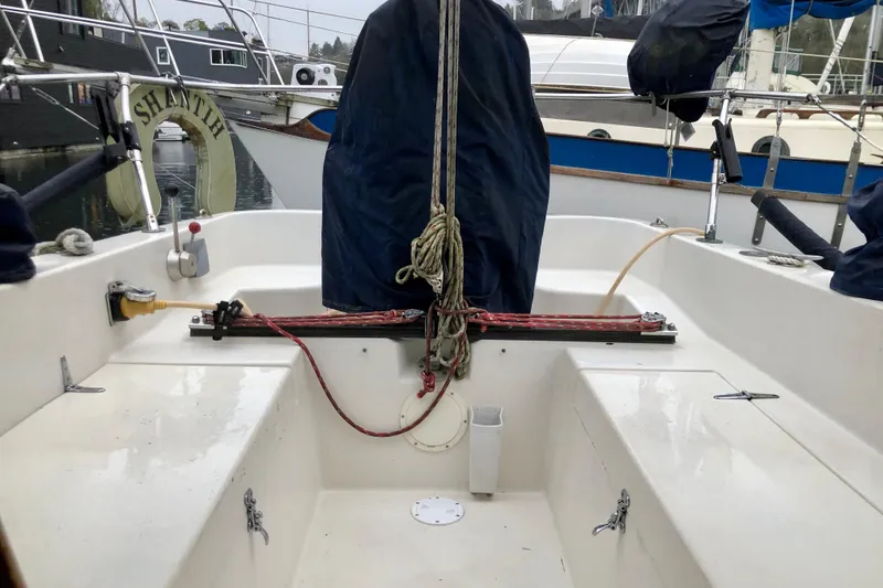 Slide: The Image of Cockpit of a 1972 C&C 35 MKI sailboat with covered equipment and ropes. - 4