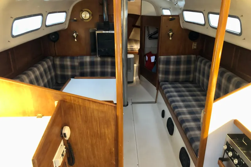 Slide: The Image of 1972 C&C 35 MKI yacht interior with plaid seating and wooden finishes. - 5