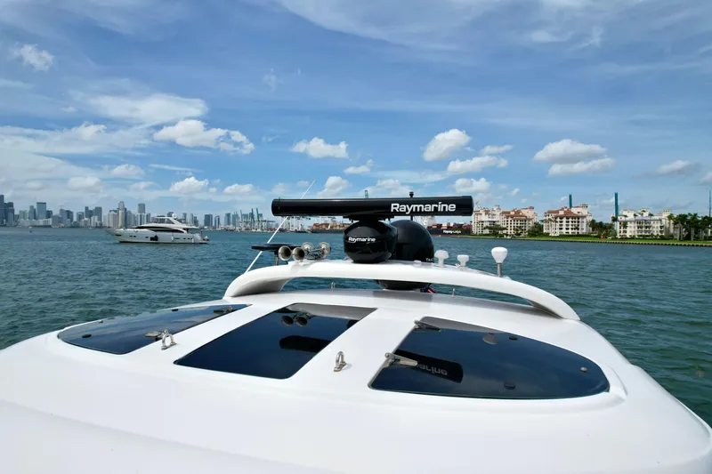 Slide: The Image of 2009 Four Winns V458 yacht cruising near city skyline under blue sky. - 16