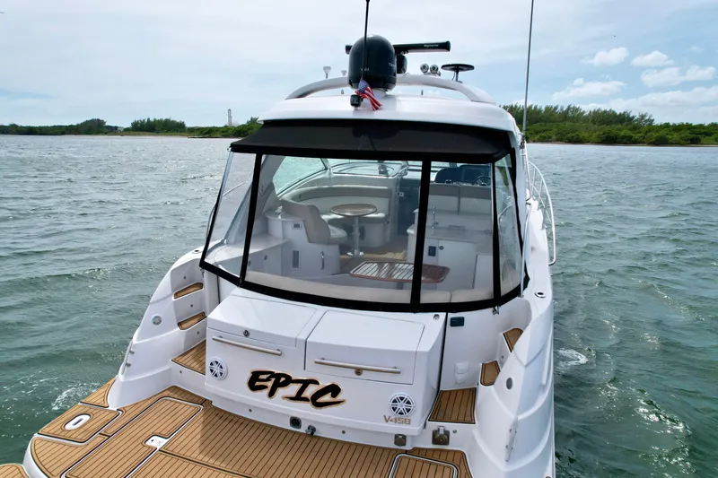 Slide: The Image of 2009 Four Winns V458 yacht on water, rear view with "EPIC" nameplate. - 17