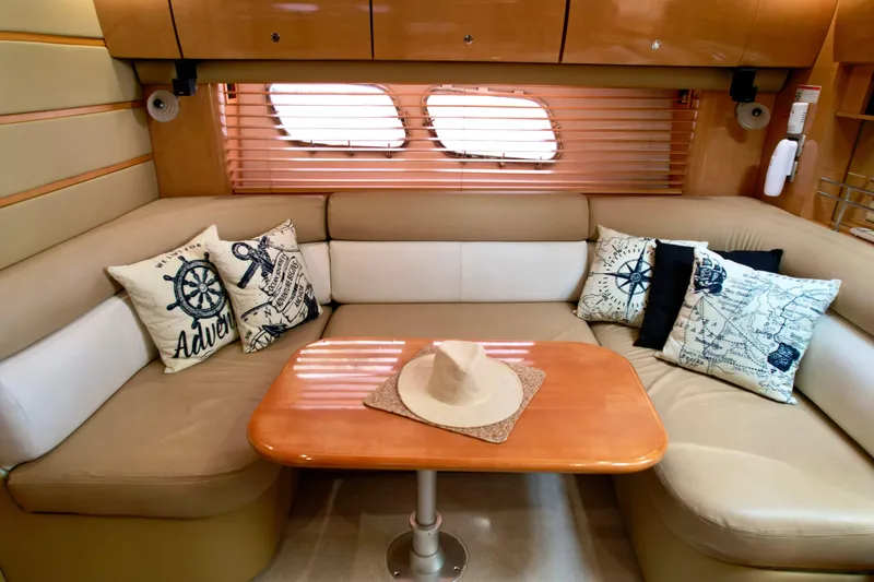 Slide: The Image of Luxurious 2009 Four Winns V458 yacht interior with cozy seating and nautical-themed decor. - 23