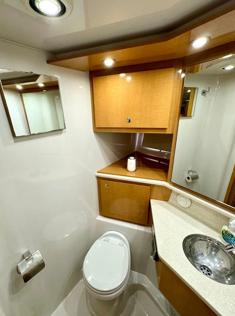 Slide: The Image of 2009 Four Winns V458 yacht bathroom with modern fixtures and wood cabinetry. - 29
