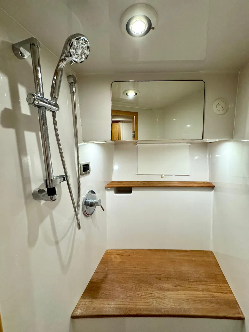 Slide: The Image of 2009 Four Winns V458 yacht shower with wooden bench and modern fixtures. - 31