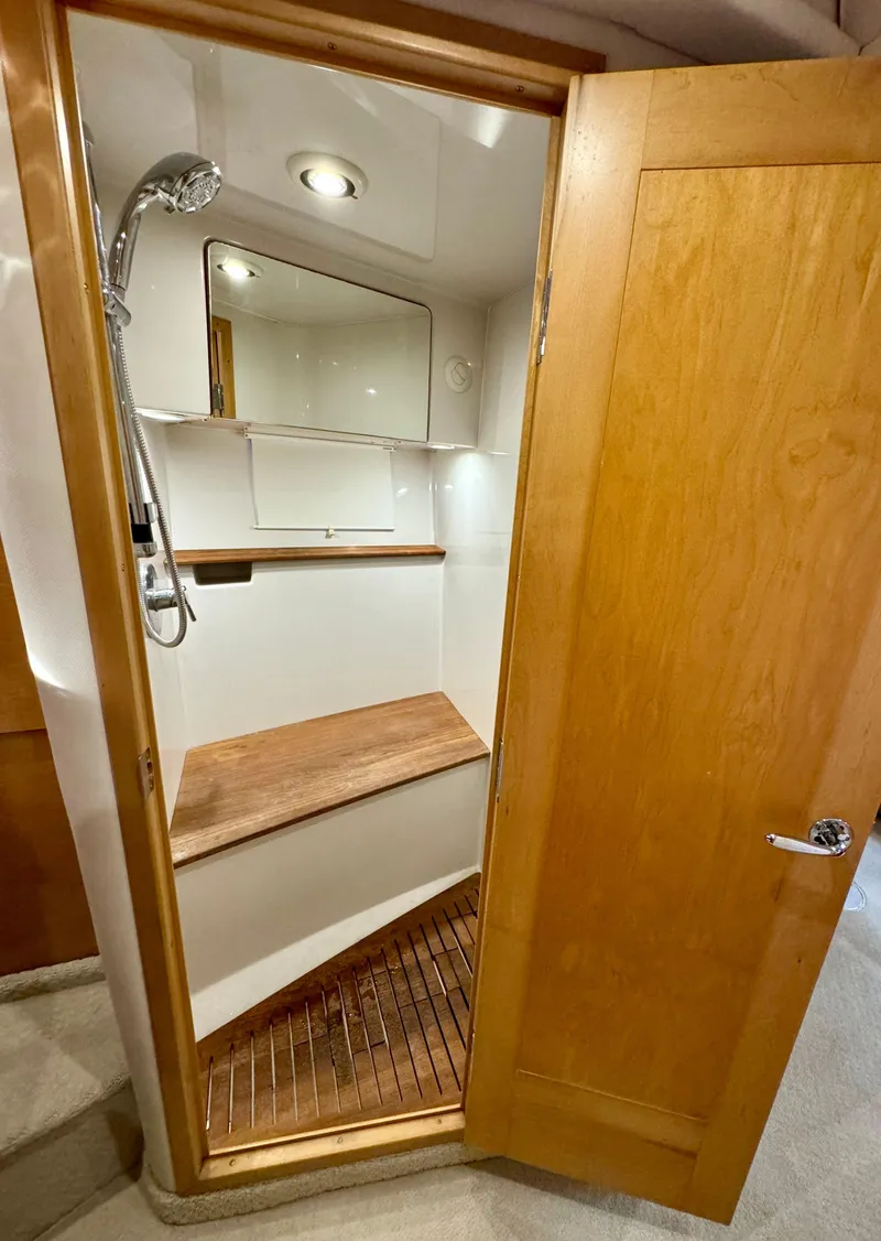 Slide: The Image of 2009 Four Winns V458 yacht bathroom with wooden door, shower, and mirror. - 32