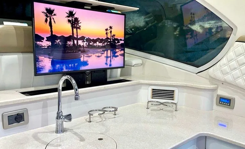 Slide: The Image of 2009 Four Winns V458 yacht interior with TV, modern kitchen, and sleek design. - 33
