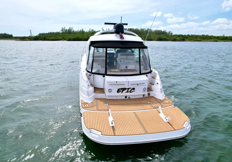 Slide: The Image of 2009 Four Winns V458 boat on water, rear view with teak deck and canopy. - 7