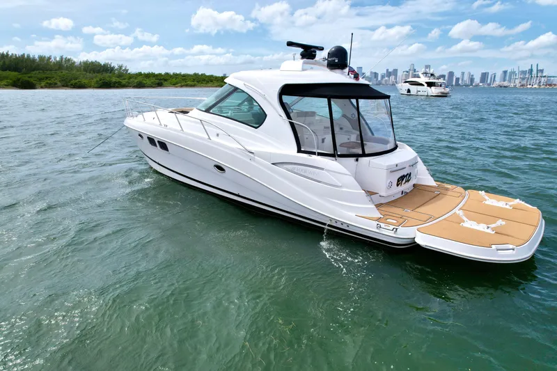 Slide: The Image of 2009 Four Winns V458 yacht on water with city skyline in background. - 8