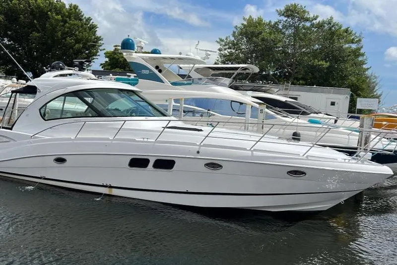 Slide: The Image of 2009 Four Winns V458 yacht docked in a marina, surrounded by other boats. - 9