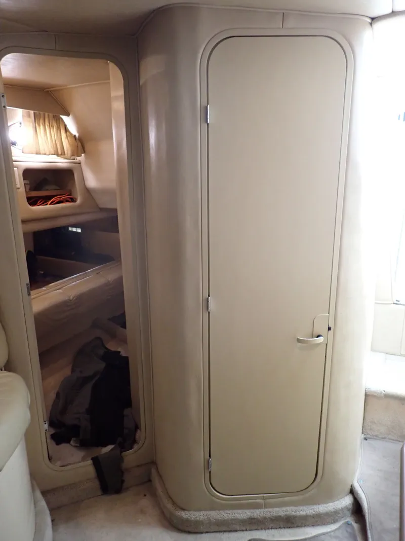 Slide: The Image of Interior of a 1998 Sea Ray Sundancer yacht with cabin door. - 10