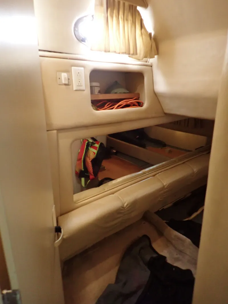 Slide: The Image of Interior of a 1998 Sea Ray Sundancer yacht with storage space. - 12