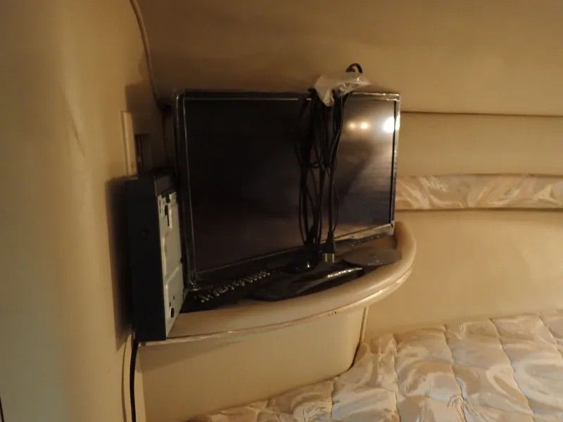 Slide: The Image of Interior of a 1998 Sea Ray Sundancer with television. - 16