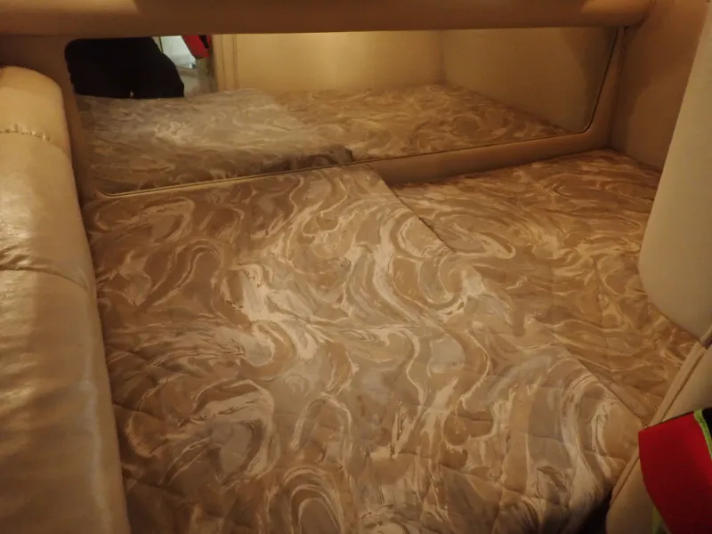 Slide: The Image of Interior of a 1998 Sea Ray Sundancer with patterned bedding. - 17