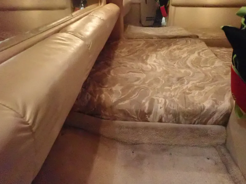 Slide: The Image of Interior of a 1998 Sea Ray Sundancer with beige upholstery. - 18