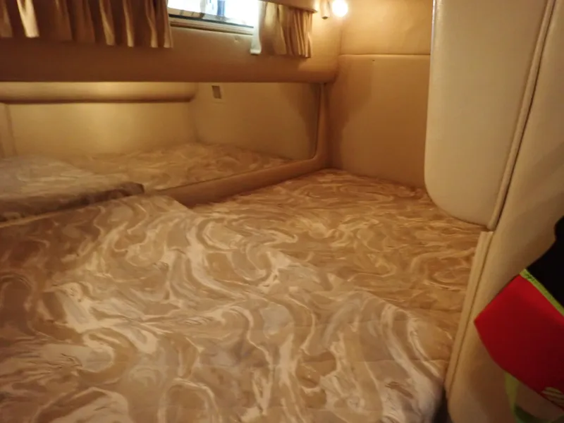 Slide: The Image of Interior of a 1998 Sea Ray Sundancer yacht with bed and curtains. - 19