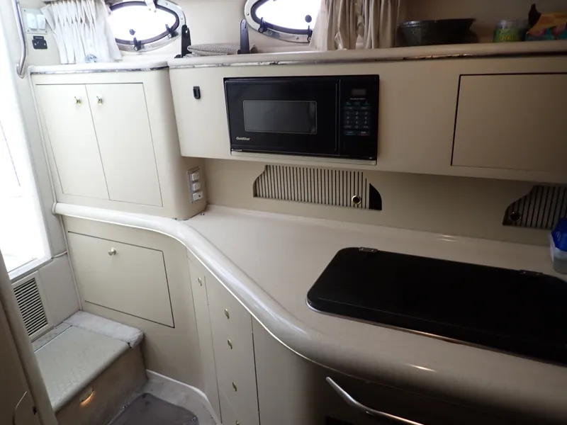 Slide: The Image of 1998 Sea Ray Sundancer interior with kitchen and microwave. - 9