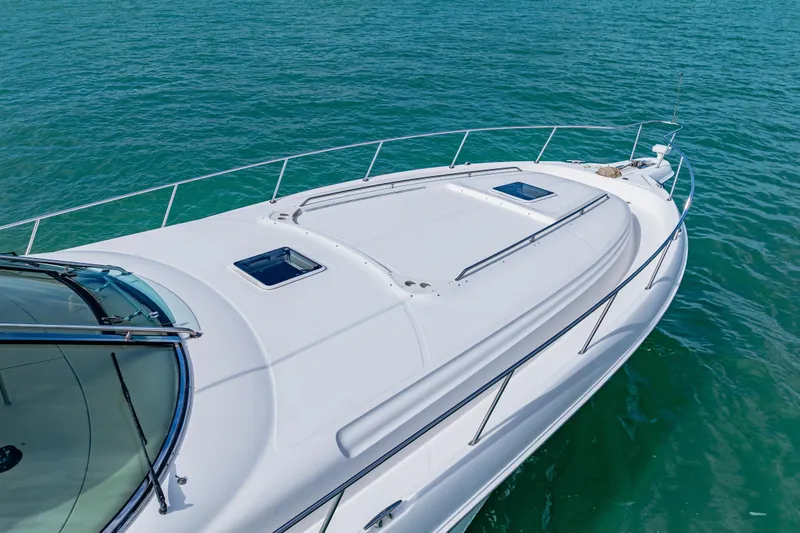 Slide: The Image of 2002 Sea Ray 460 Sundancer yacht on clear blue water, showcasing sleek design. - 10
