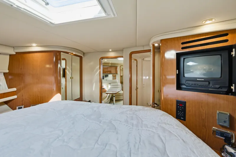 Slide: The Image of Luxurious interior of 2002 Sea Ray 460 Sundancer yacht with wood paneling and cozy furnishings. - 17