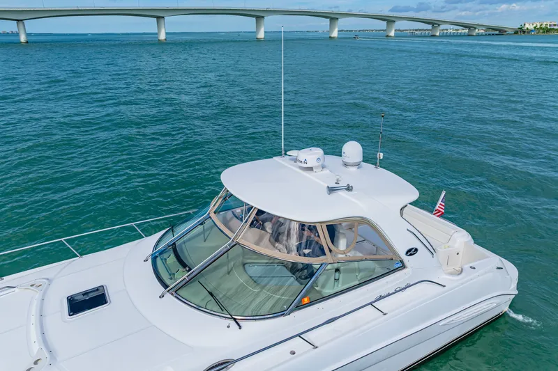 Slide: The Image of 2002 Sea Ray 460 Sundancer yacht cruising under a bridge on a sunny day. - 2