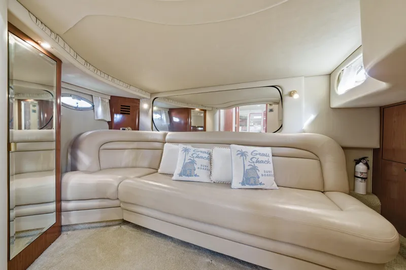Slide: The Image of Luxurious interior of 2002 Sea Ray 460 Sundancer yacht with plush seating and decorative pillows. - 20
