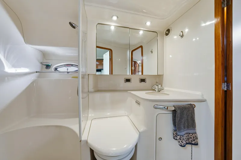 Slide: The Image of Luxurious bathroom in 2002 Sea Ray 460 Sundancer yacht, featuring modern fixtures and elegant design. - 21
