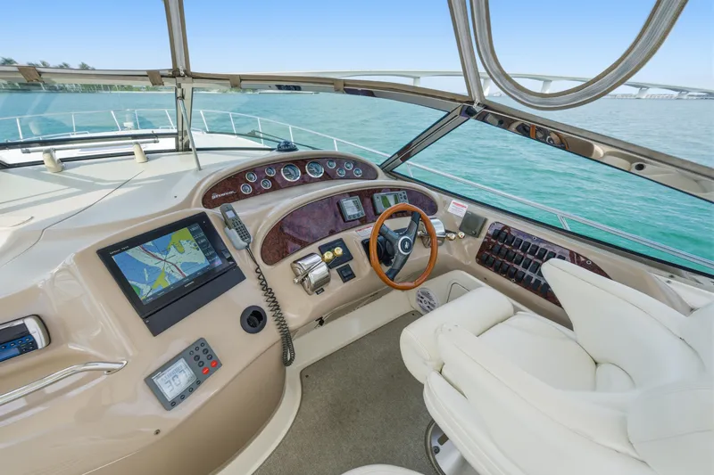 Slide: The Image of Helm of 2002 Sea Ray 460 Sundancer yacht with navigation equipment and steering wheel. - 25