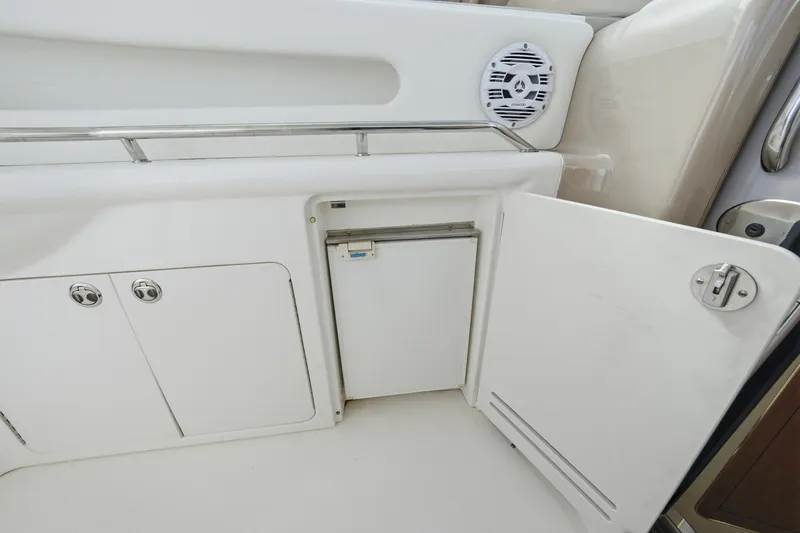 Slide: The Image of 2002 Sea Ray 460 Sundancer yacht interior with open storage compartments and speaker. - 27