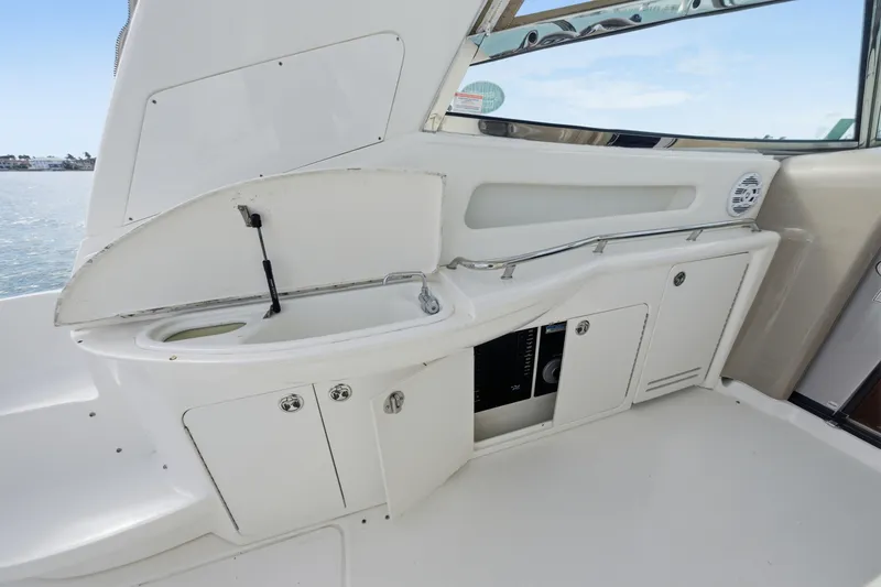 Slide: The Image of 2002 Sea Ray 460 Sundancer yacht interior with sink and storage cabinets. - 28