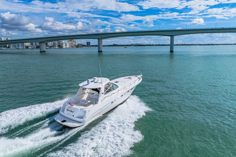 Slide: The Image of 2002 Sea Ray 460 Sundancer cruising under a bridge on a sunny day. - 39