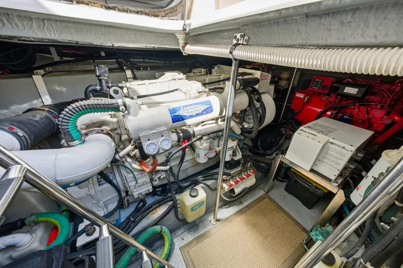 Slide: The Image of Engine room of 2002 Sea Ray 460 Sundancer yacht, showcasing mechanical components and systems. - 42