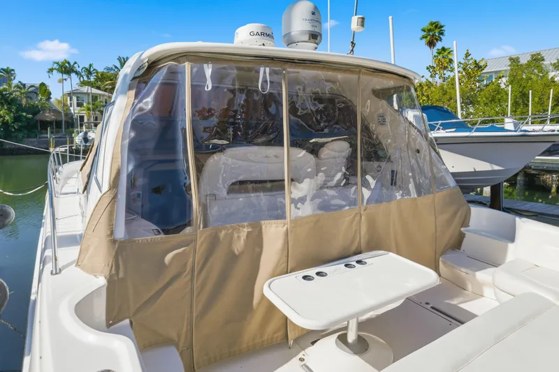 Slide: The Image of 2002 Sea Ray 460 Sundancer yacht with covered cockpit and seating area. - 50