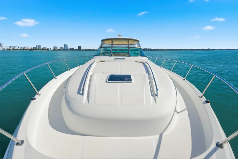 Slide: The Image of 2002 Sea Ray 460 Sundancer yacht cruising on clear blue waters. - 7