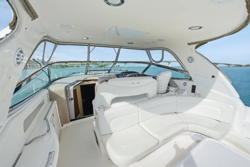 Slide: The Image of 2002 Sea Ray 460 Sundancer yacht interior with white seating and ocean view. - 25