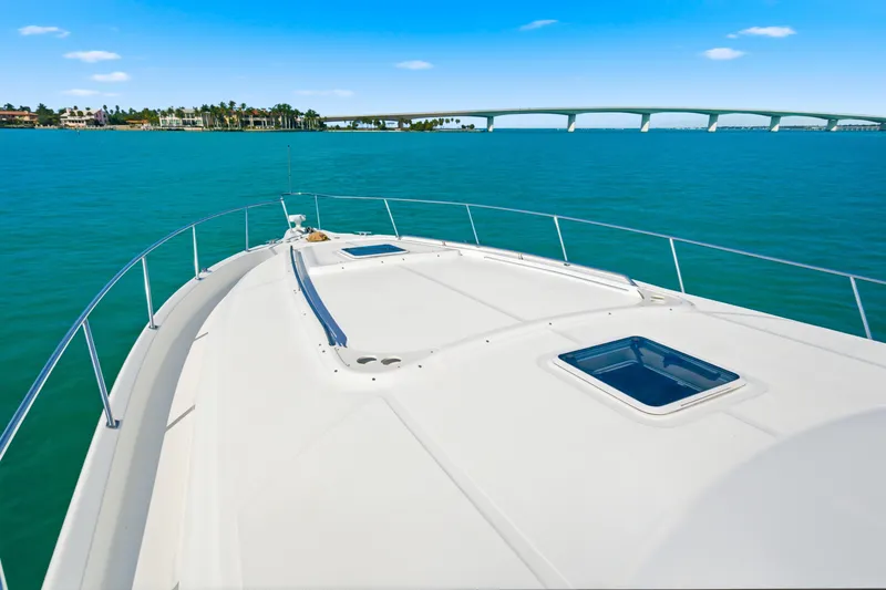 Slide: The Image of Bow view of 2002 Sea Ray 460 Sundancer yacht on open water. - 9