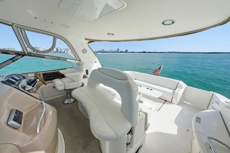 Slide: The Image of Luxurious 2002 Sea Ray 460 Sundancer yacht interior with ocean view and American flag. - 23