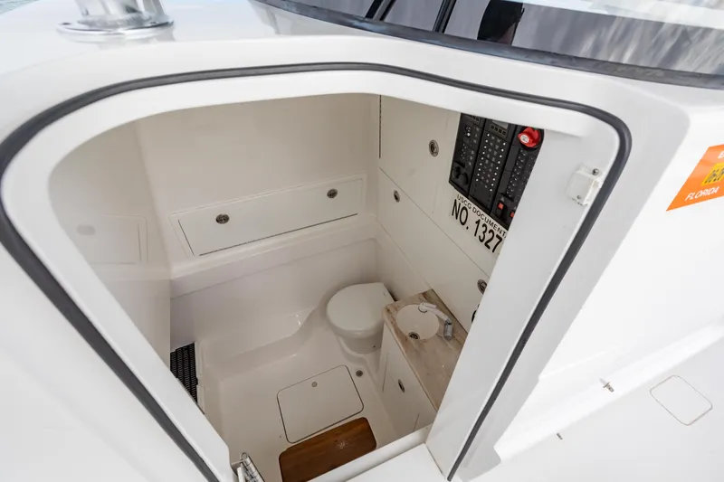 Slide: The Image of 2022 Valhalla Boatworks V-41 deck with open storage compartments and visible equipment. - 21