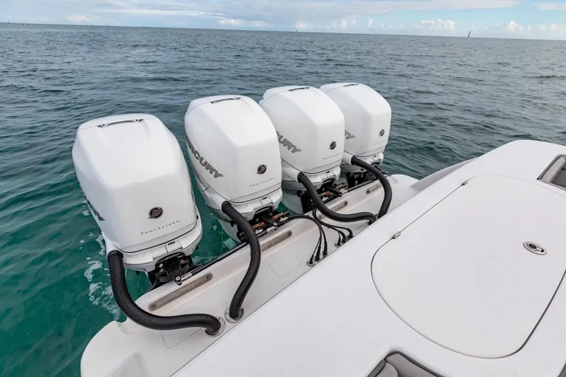 Slide: The Image of 2022 Valhalla Boatworks V-41 interior with luxurious seating, ocean view, and coastal buildings. - 27