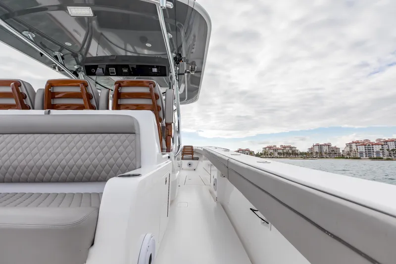 Slide: The Image of 2022 Valhalla Boatworks V-41 cruising in a scenic harbor with city skyline backdrop. - 34