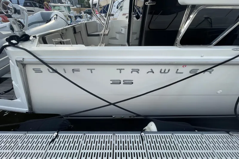 Slide: The Image of 2018 Beneteau Swift Trawler 35 docked, showcasing sleek design and modern features. - 14